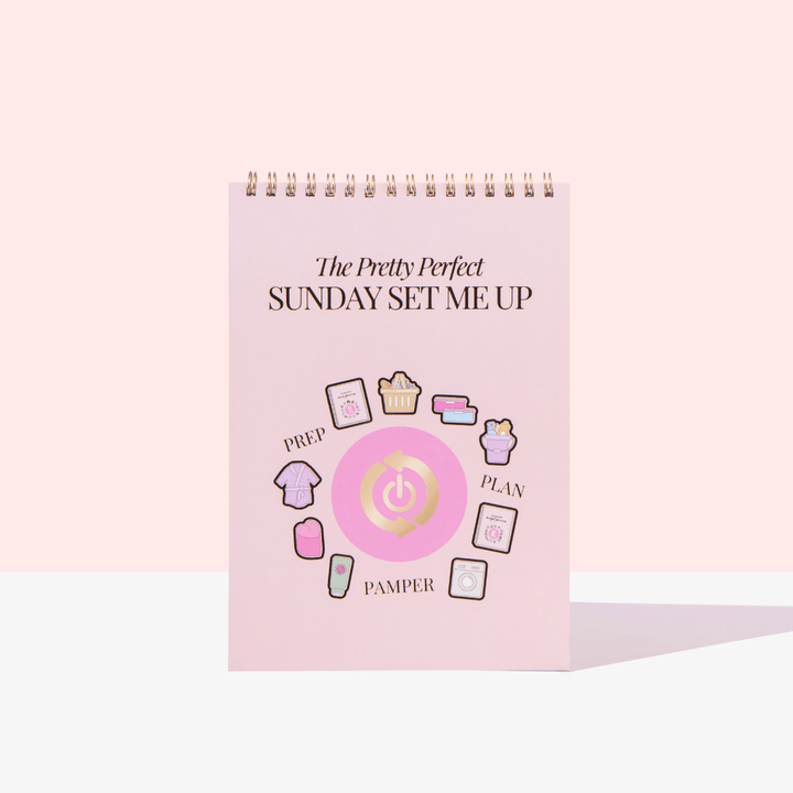 Pink planner with icons and text on a white background